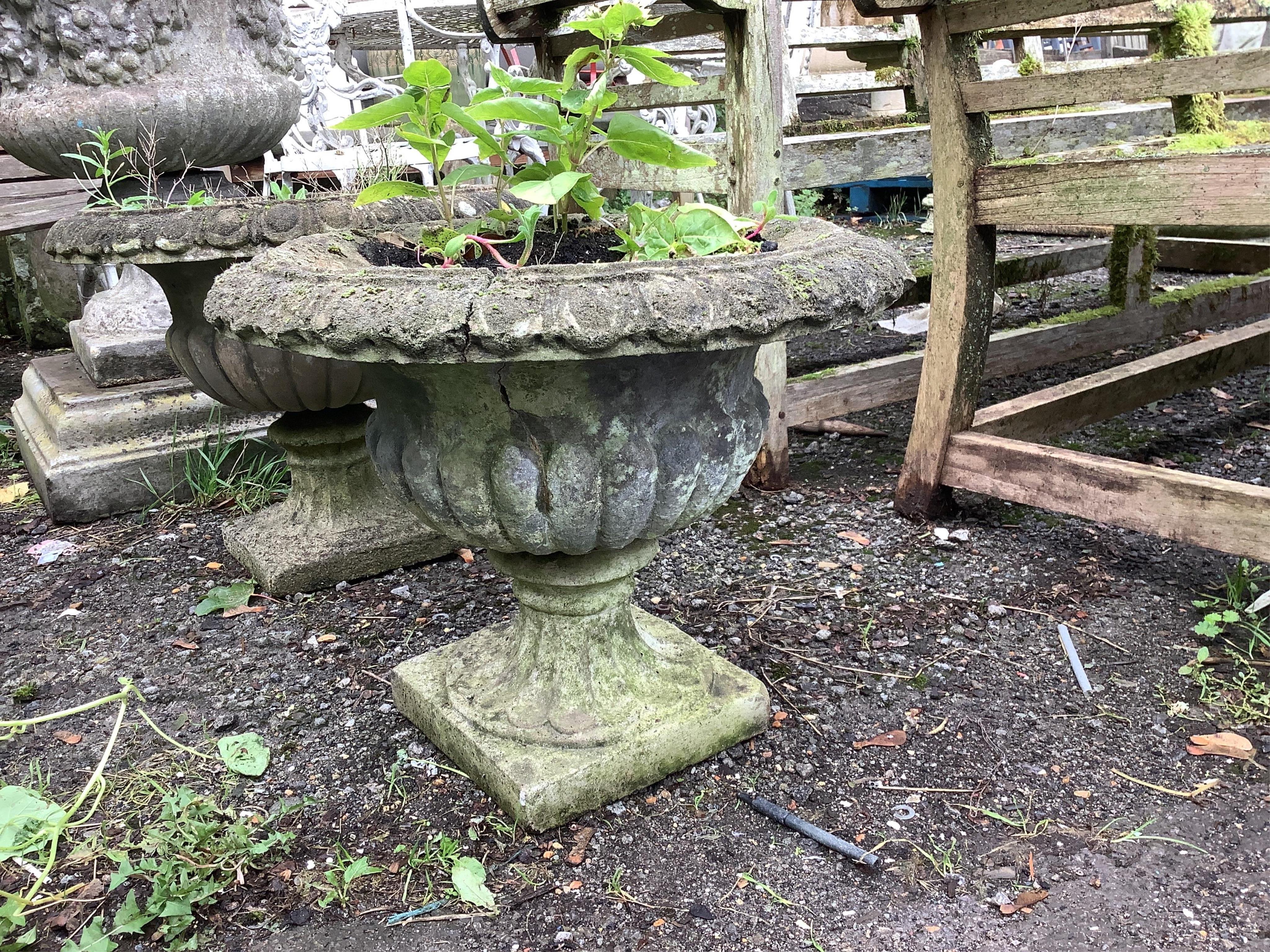 A pair of reconstituted stone campana garden urns, diameter 50cm, height 40cm. Condition - poor